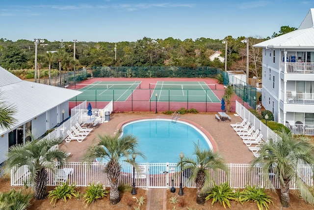 view of swimming pool featuring tennis court