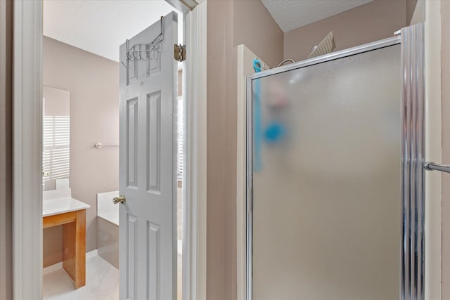 bathroom featuring a textured ceiling and walk in shower