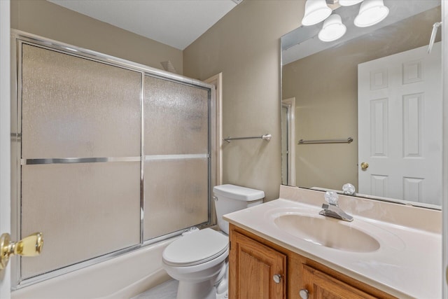 full bathroom with vanity, toilet, and bath / shower combo with glass door