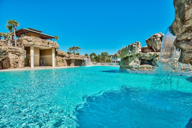 view of swimming pool with pool water feature