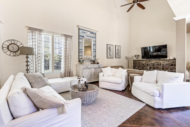 living room featuring ceiling fan, a towering ceiling, and dark wood-type flooring