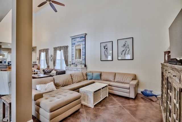 living room with a towering ceiling and ceiling fan