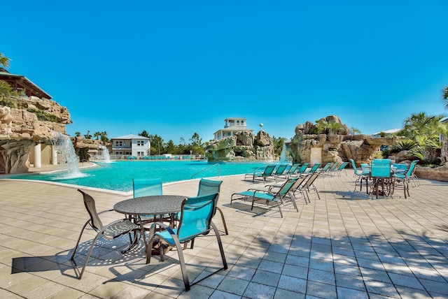 view of pool featuring pool water feature and a patio area