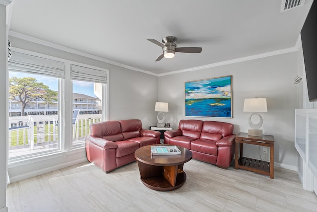 living room with ceiling fan and ornamental molding