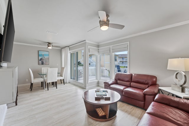 living room with ceiling fan, light wood-type flooring, and ornamental molding