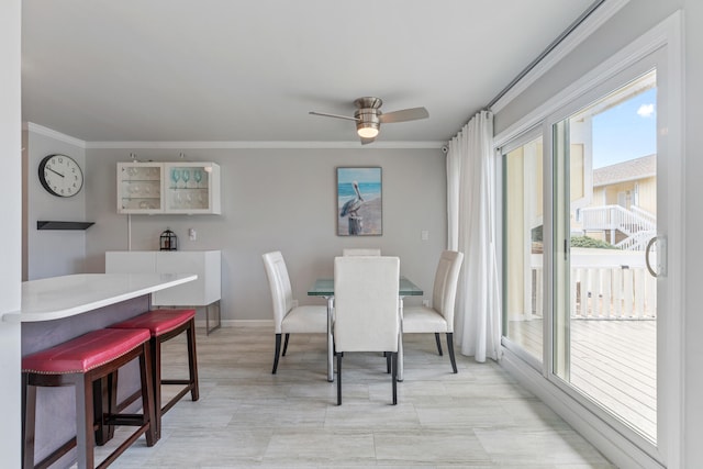 dining room with ceiling fan and ornamental molding