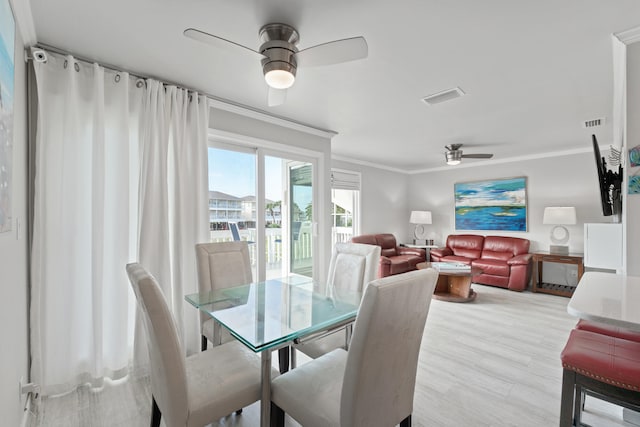 dining space with ceiling fan, light hardwood / wood-style flooring, and ornamental molding