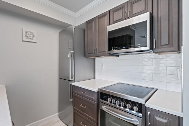 kitchen featuring backsplash, dark brown cabinetry, stainless steel appliances, and light hardwood / wood-style flooring