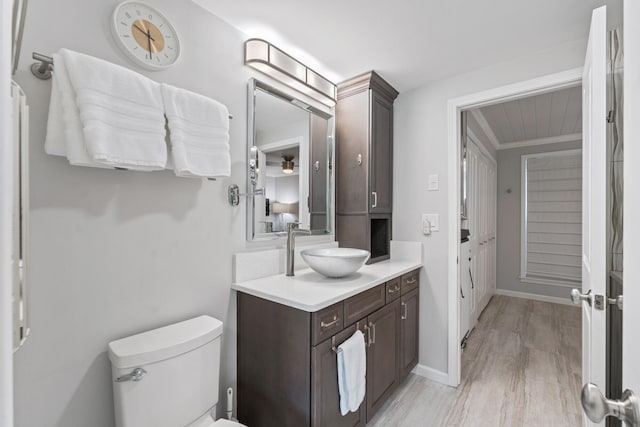 bathroom featuring vanity, hardwood / wood-style flooring, and toilet