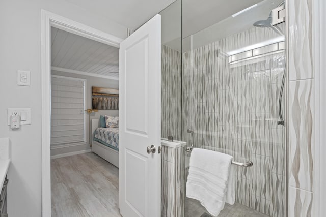 bathroom with hardwood / wood-style flooring and walk in shower