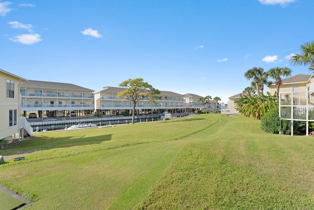 view of community featuring a yard and a water view