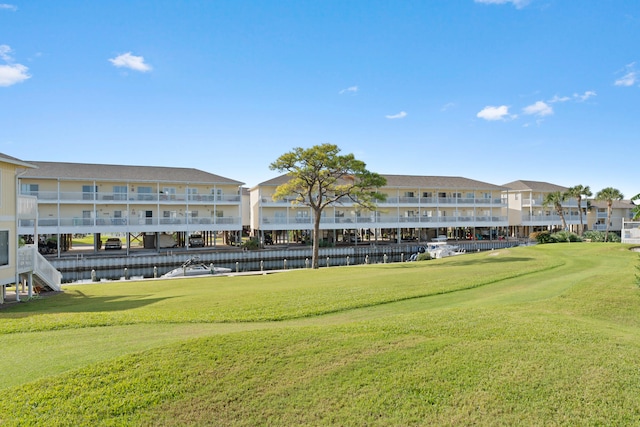 view of community featuring a lawn and a water view