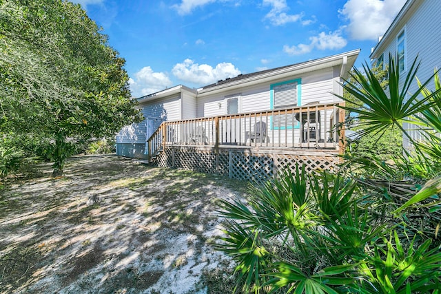 rear view of property with a wooden deck