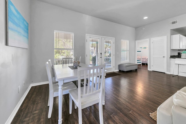 dining area featuring french doors and dark wood-type flooring