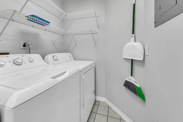 laundry room featuring separate washer and dryer and light tile patterned floors