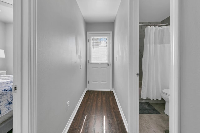 hallway with dark hardwood / wood-style floors