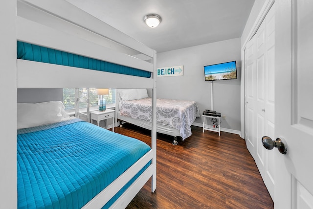 bedroom featuring dark hardwood / wood-style floors and a closet