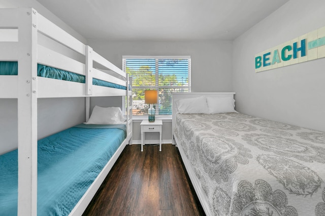 bedroom with dark hardwood / wood-style flooring