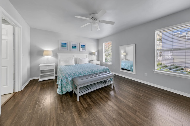 bedroom with multiple windows, dark wood-type flooring, and ceiling fan