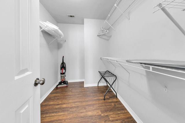 walk in closet featuring dark wood-type flooring