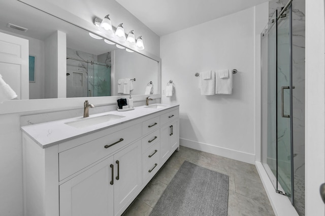 bathroom featuring tile patterned floors, vanity, and walk in shower