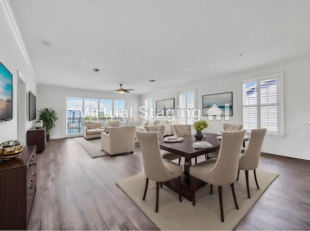 dining space featuring light hardwood / wood-style floors, ceiling fan, and ornamental molding