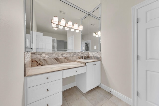 bathroom with tile patterned floors, vanity, and backsplash