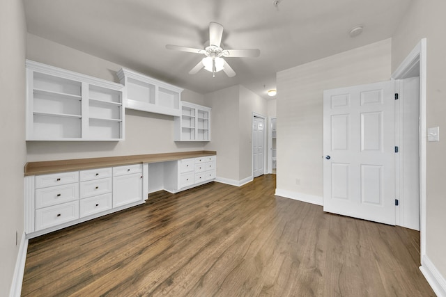 kitchen featuring white cabinets, dark hardwood / wood-style floors, butcher block counters, and built in desk