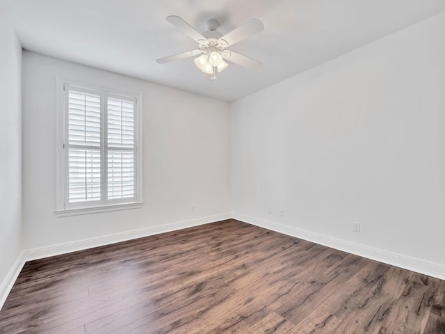 unfurnished room with ceiling fan and dark wood-type flooring