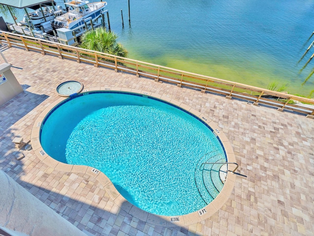 view of swimming pool featuring a water view