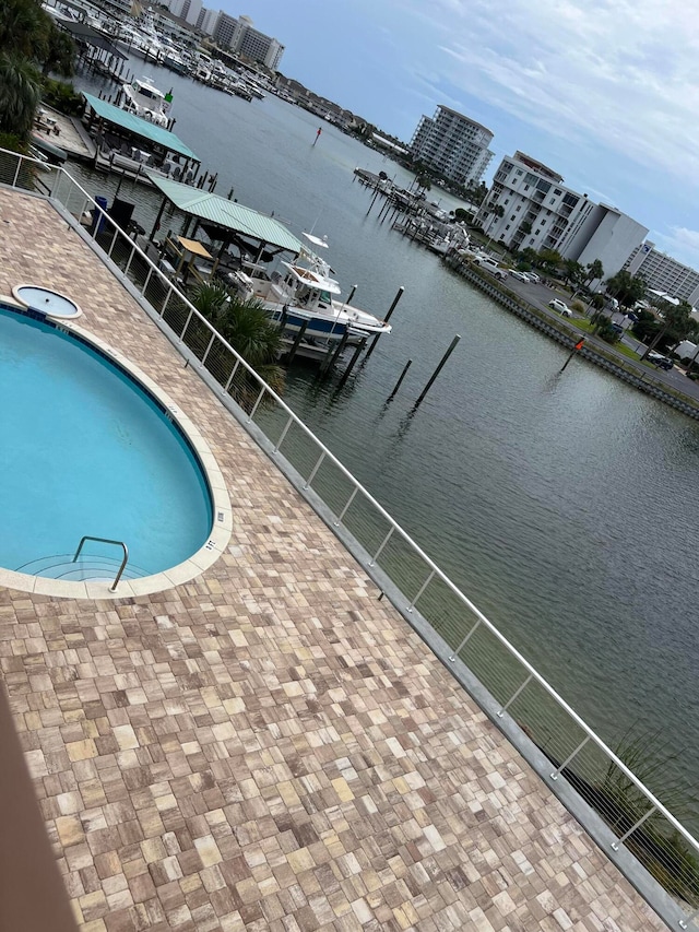 view of swimming pool featuring a water view