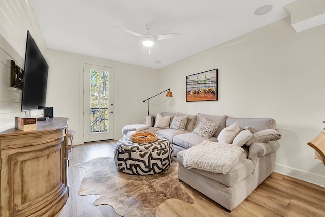 living room featuring ceiling fan, light hardwood / wood-style floors, and ornamental molding