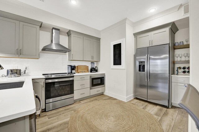 179 S County Highway 393 # 324, Santa Rosa Beach, FL 32459 - kitchen featuring stainless steel appliances, wall chimney range hood, gray cabinets, light countertops, and recessed lighting