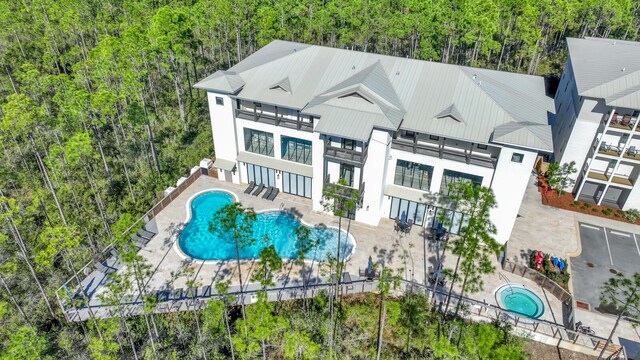 179 S County Highway 393 # 324, Santa Rosa Beach, FL 32459 - back of property with a balcony, a standing seam roof, a patio, metal roof, and a community hot tub