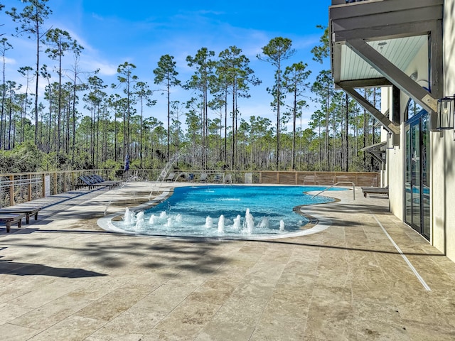 view of pool with pool water feature and a patio area