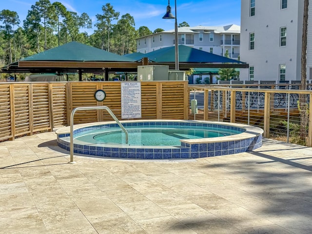 view of swimming pool with a gazebo and a community hot tub