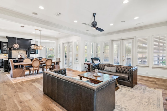 living room with ceiling fan, light hardwood / wood-style flooring, and ornamental molding