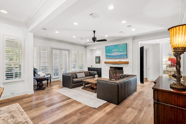 living room with ceiling fan, light hardwood / wood-style floors, and ornamental molding