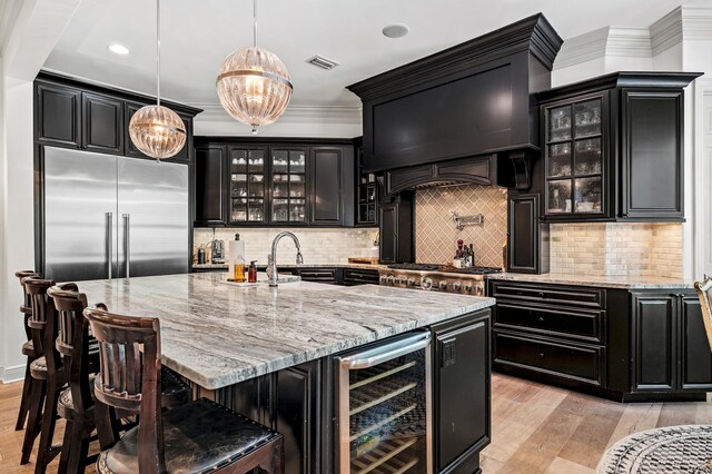 bar with hanging light fixtures, wine cooler, light wood-type flooring, decorative backsplash, and ornamental molding