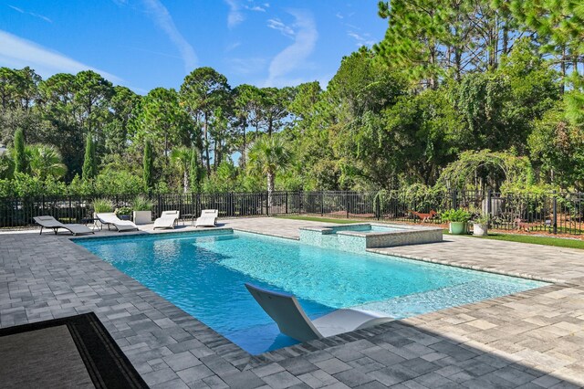 view of pool with a patio area and an in ground hot tub