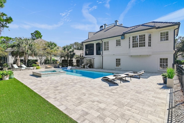 view of pool featuring a patio area and an in ground hot tub