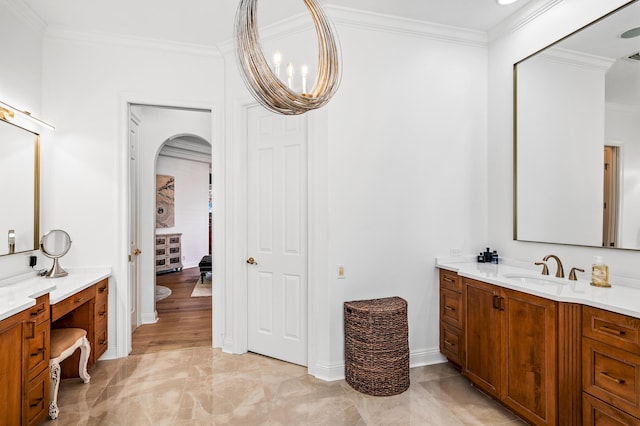 bathroom featuring hardwood / wood-style flooring, vanity, a notable chandelier, and ornamental molding