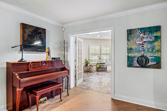 miscellaneous room with hardwood / wood-style flooring, ornamental molding, and french doors