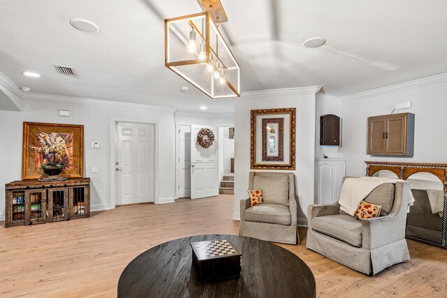 living room featuring light hardwood / wood-style floors and ornamental molding