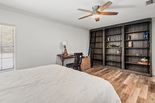 bedroom featuring crown molding, ceiling fan, and light hardwood / wood-style floors