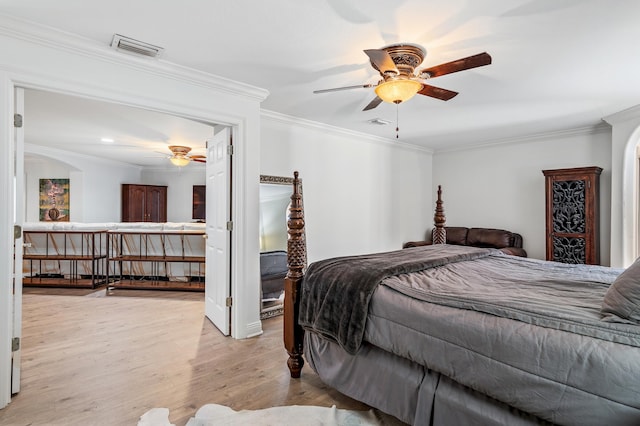 bedroom featuring ceiling fan, light hardwood / wood-style floors, and ornamental molding