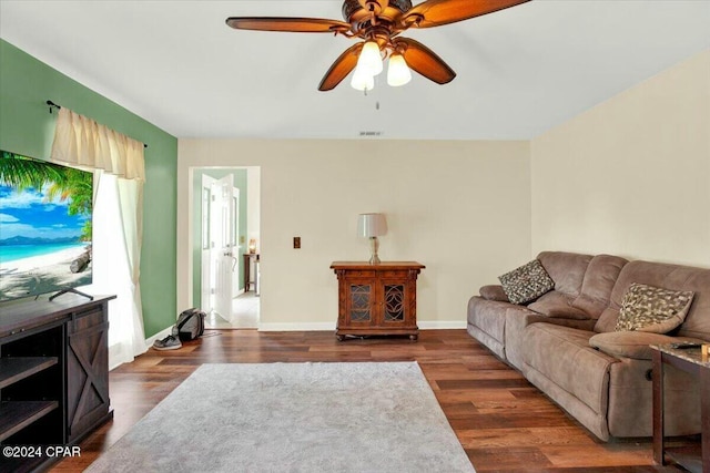 living room with ceiling fan and dark hardwood / wood-style floors