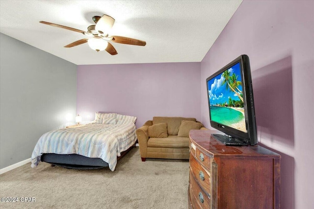 carpeted bedroom with a textured ceiling and ceiling fan