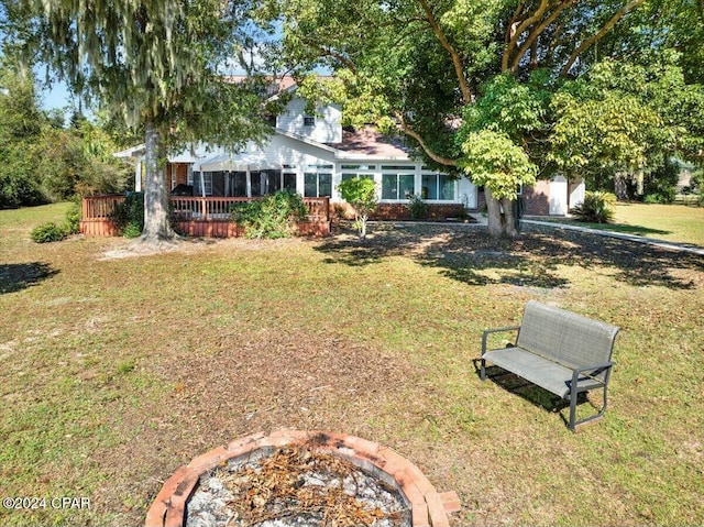 view of front of house featuring a sunroom and a front lawn