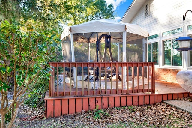 wooden deck with a sunroom